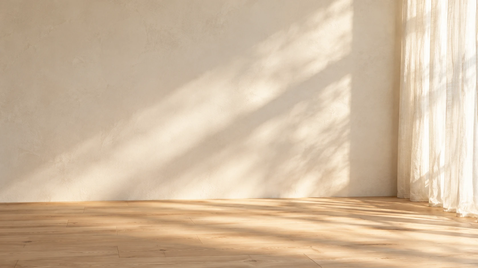 Soft window light across a warm neutral wall and wood floor